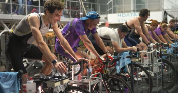 Group of cyclists participating in an indoor cycling session, focused on training and fitness.