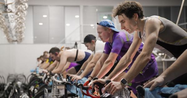 Athletes engaged in a high-intensity indoor cycling session, enhancing fitness and endurance.