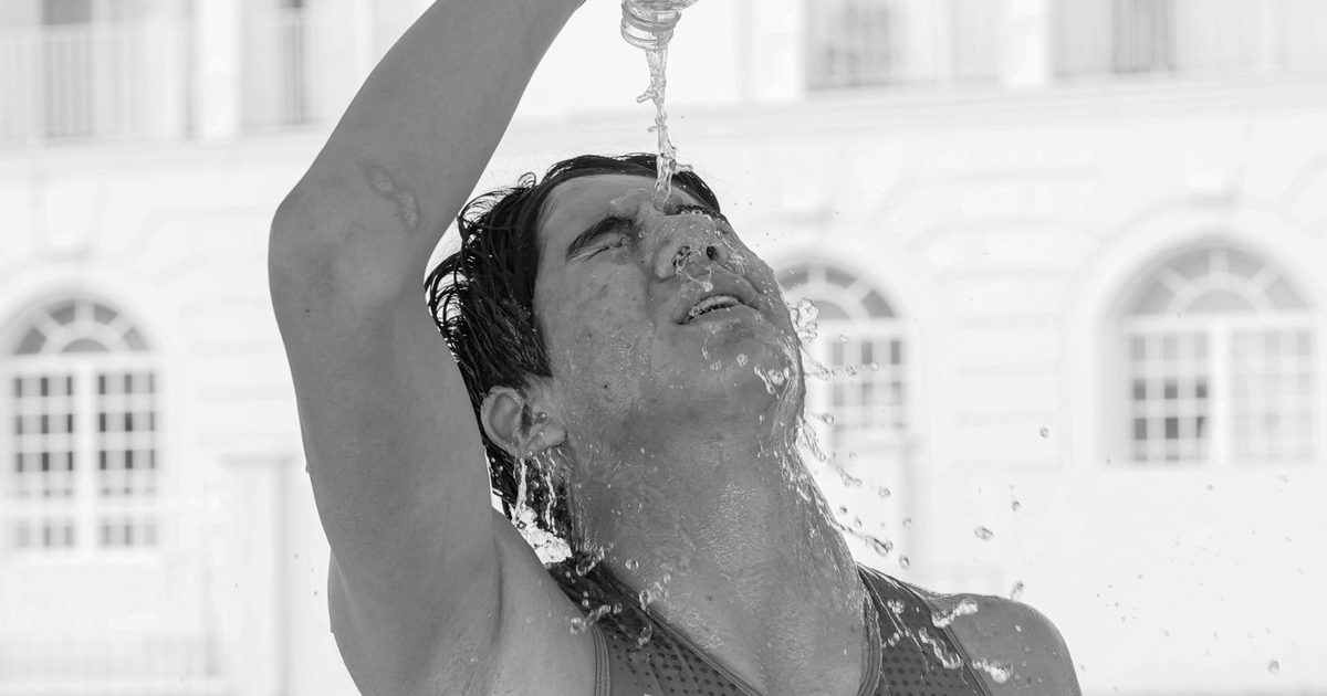 A male athlete refreshes with water, cooling down during a hot race in Ciudad Madero, Mexico.