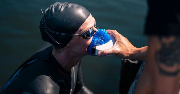 A swimmer uses a rescue mask for oxygen after completing an outdoor swim.