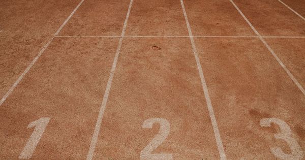 Outdoor sports track with lanes numbered 1 to 3, ready for an athletic event.