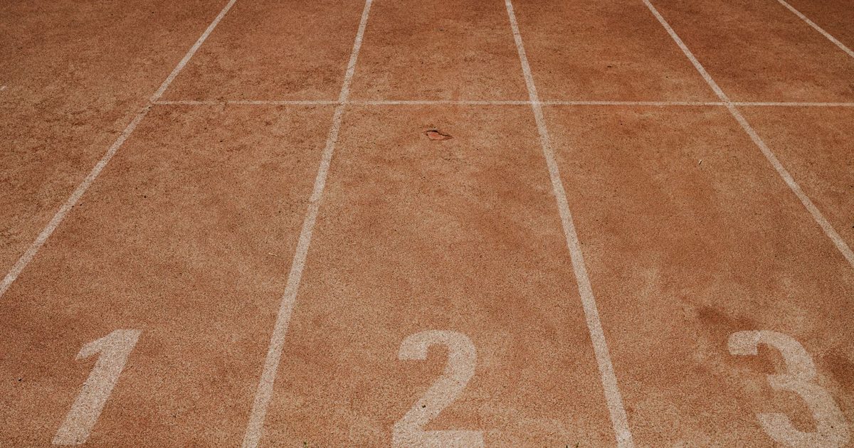 Outdoor sports track with lanes numbered 1 to 3, ready for an athletic event.
