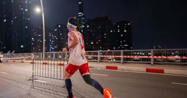 Runner in bright urban environment participating in night marathon.